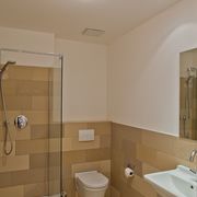 Beleuchtung eines Badezimmers mit Dusche und braunen Fliesen
